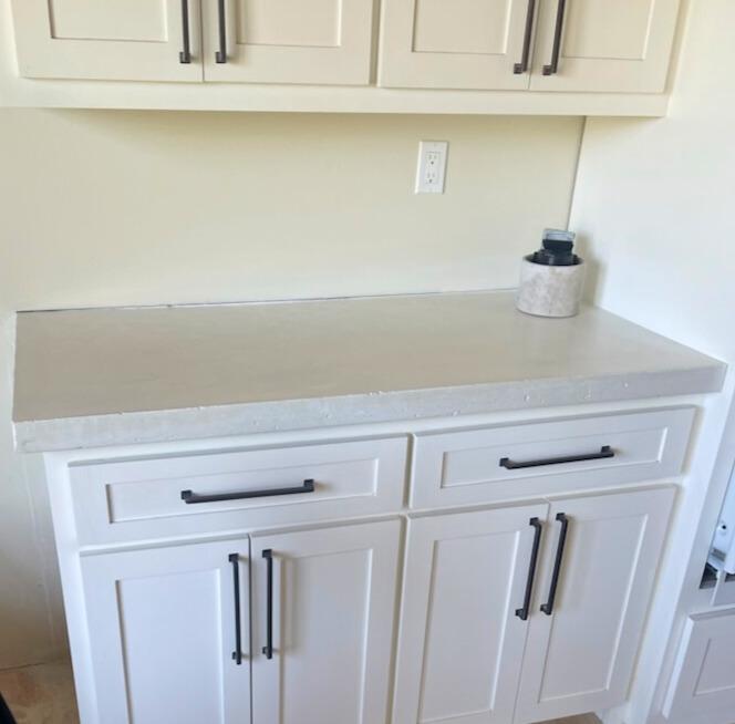 Cast-in-place antique white countertops with distressed square edge.